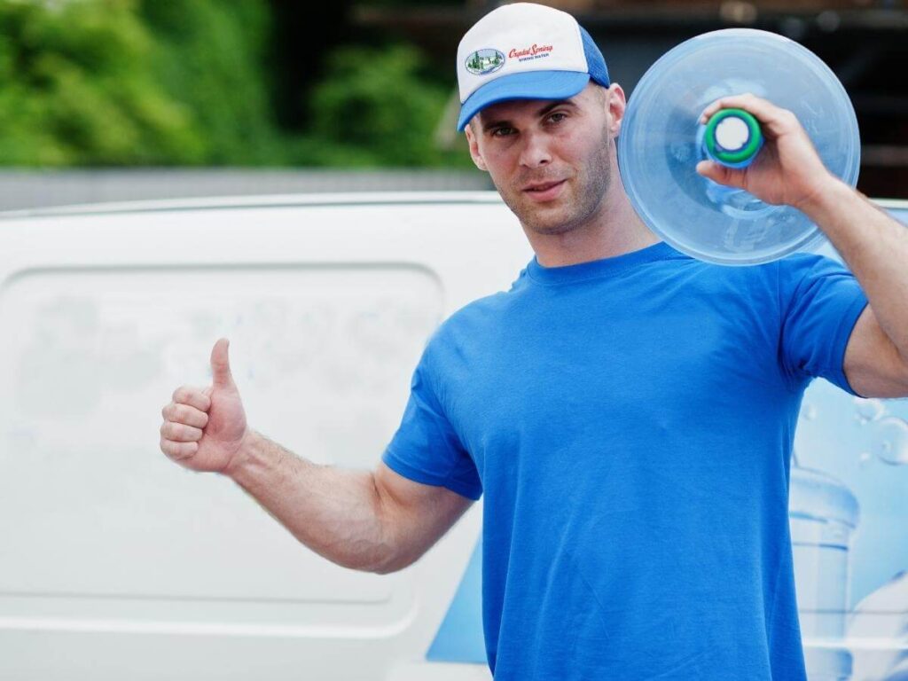 Man delivering water bottle to home